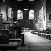 man sitting in an empty church