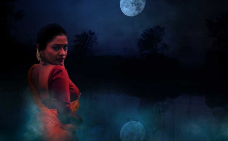 girl standing in front of a pond in a misty night