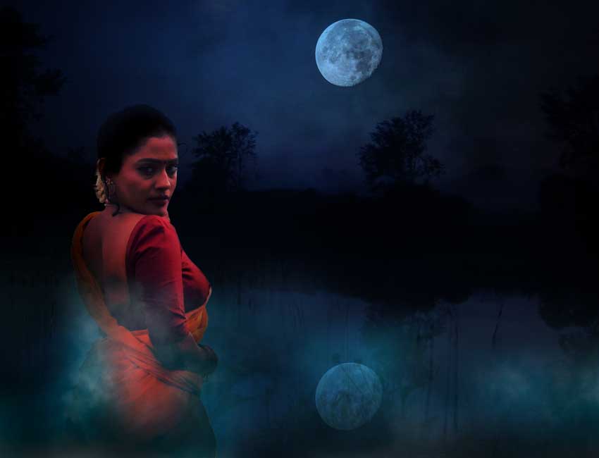 girl standing in front of a pond in a misty night