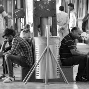 people waiting for the train in the paltform of a railway station