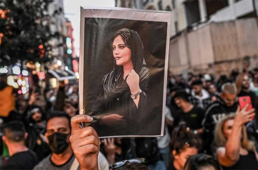 A protestor holding Mahsa Amini's picture