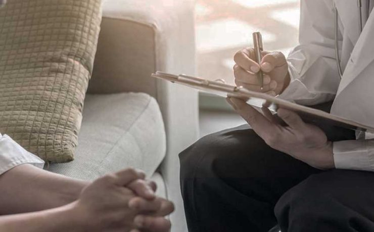 The patient sitting with a Psychiatrist