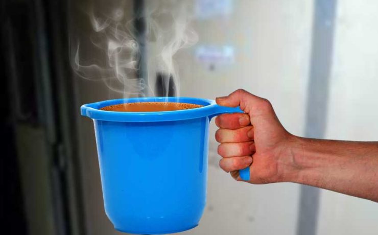 hand holding a mug full of tea