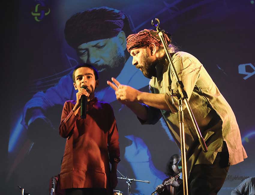 Young boy performing with Debojyoti Mishra at Music Pathshala event