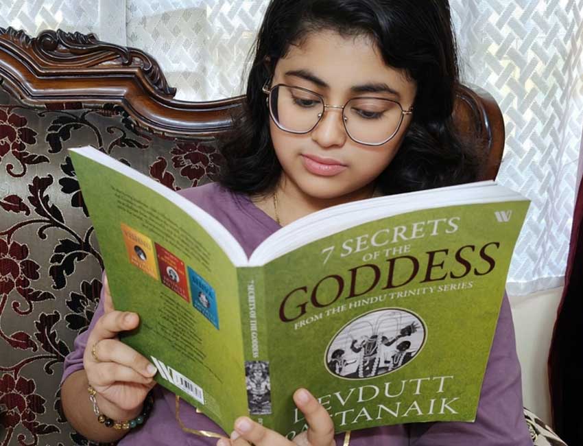 Aarna reading the book '7 SECRETS OF THE GODDESS'