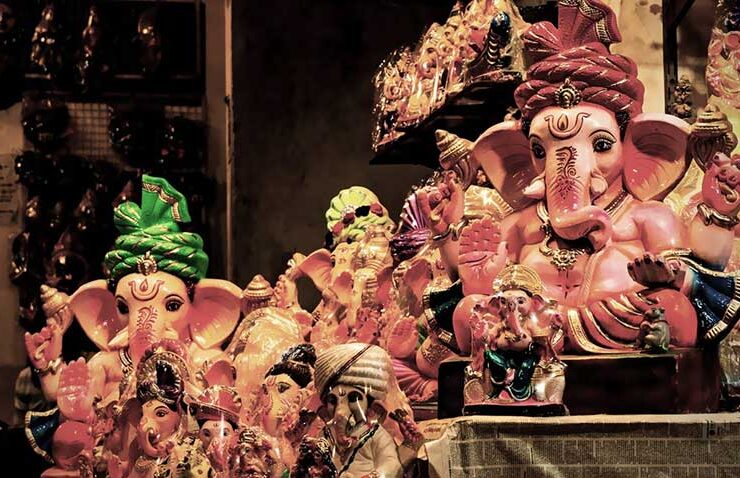 Vibrant, hand-painted idols of Lord Ganesha—adorned in colorful turbans and traditional attire—fill the stalls as markets prepare for the festive celebrations of Ganesh Chaturthi.