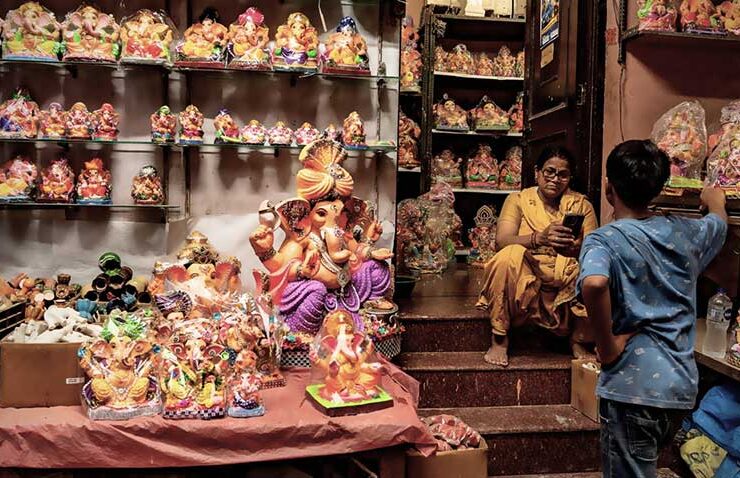 A small shop transforms into a radiant gallery of devotion in preparation for Ganesh Chaturthi. Shelves packed with a multitude of intricately crafted Lord Ganesha idols, each radiating with vibrant, traditional colors and detailed adornments, offer a spiritual feast for the eyes.